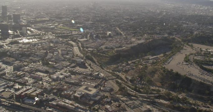 Aerial shot, day, pan left from Dodger stadium to show downtown LA and surrounding neighborhoods, drone