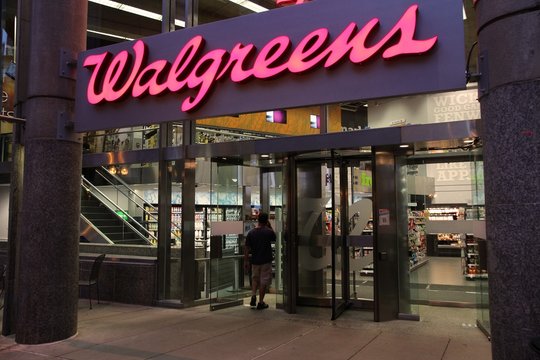 BOSTON - JUNE 9: Shopper enters Walgreens store on June 9, 2013 in Boston. Walgreens is the largest drug retail chain in the United States with 8,300 stores in 50 states.