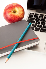 FIRST APPLE PLANE ON WORK TABLE WITH NOTEBOOK AND COMPUTER