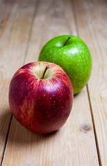 RED AND GREEN APPLES ON WOODEN TABLE. HEALTHY FOOD