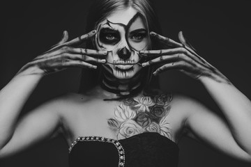 Pretty female with scared makeup and body art