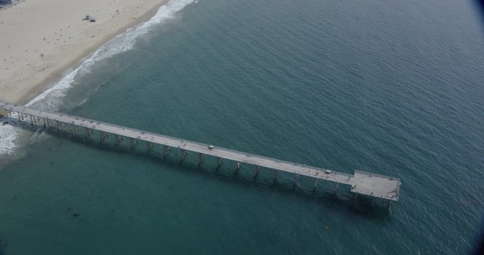Aerial shot, day, high altitude view of pier above sea on la beach, drone