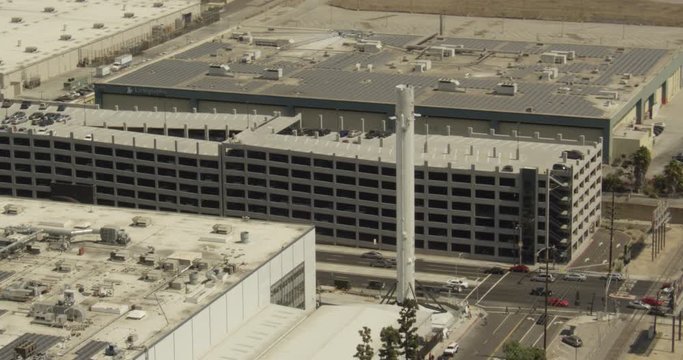 Aerial shot, day, zoom in view of FALCON 9 booster at Spacex HQ, drone