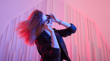 Beautiful girl dancing in retro wave on the neon light