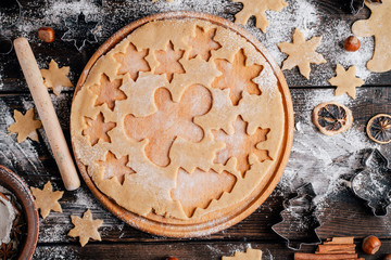 Christmas and New Year celebration traditions. Family home bakery, cooking traditional festive sweets. Gingerbread dough with christmas theme shapes and raw cookies, flat lay