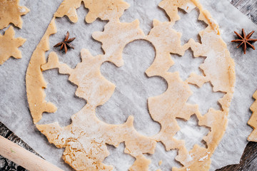 Christmas and New Year celebration traditions. Family home bakery, cooking traditional festive sweets. Gingerbread dough with christmas theme shapes and raw cookies
