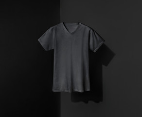 Black t-shirt for man on shadowed background