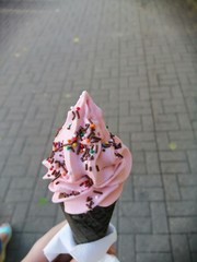woman with ice cream in hand on background