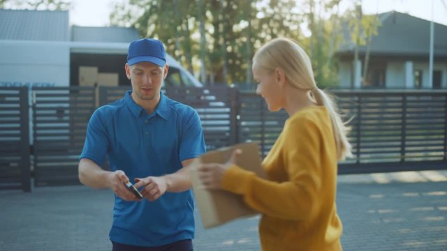 Beautiful Young Woman Opens Doors of Her House and Meets Delivery Man who Gives Her Cardboard Box Postal Package, She Signs Electronic Signature POD Device. 