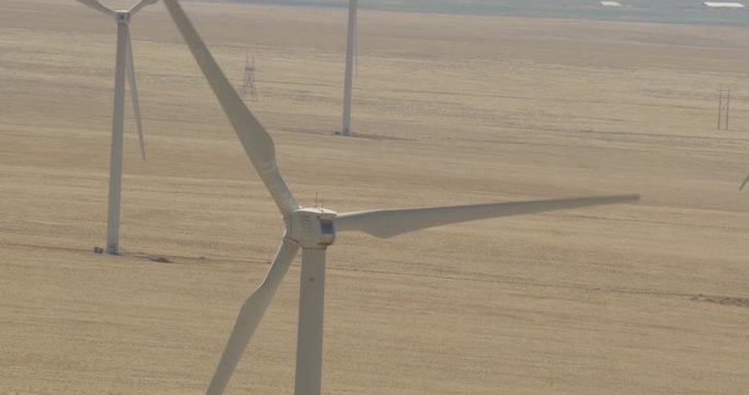 Aerial shot, day, extreme zoom, slowmo shot on wind turbines, drone
