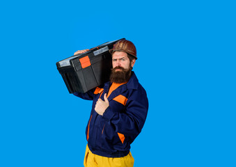 Man with toolbox giving thumbs up. Tools for repair. Repair. Handyman concept. Builder man carrying tool box. Repairman in overall hold toolbox. Builder in protective helmet with toolbox. Repair kit.
