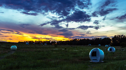 Sunset in big city park over biogas wells