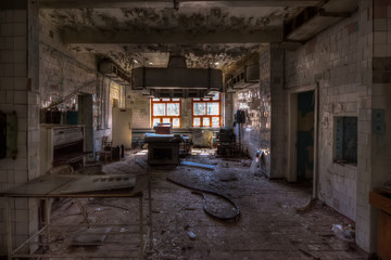 Abandoned and ruined kitchen of closed factory canteen or restaurant