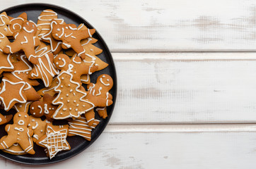 gingerbread christmas cookies on white wooden boards.