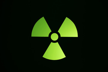 Green radiation and hazard symbol sign on a dark background.Danger concept