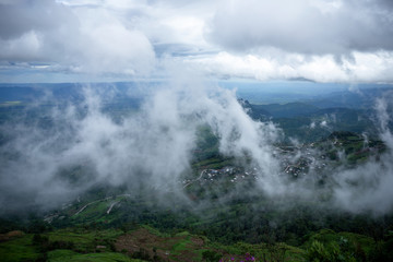 A small village in the midst of mountains in the atmosphere of morning mist.
