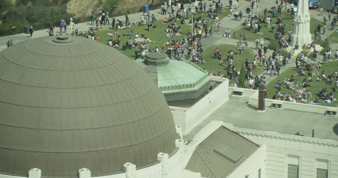 Aerial shot, day, zoom on large crowd gathered on lawns of griffith observatory, drone