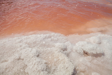 Pink waters during the evaporation process of seawater in the production of table salt. Macau Saline on the coast of Rio Grande do Norte-Brazil, producers of sea salt.