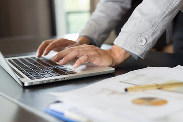 Fototapeta premium Asian businessman of analysis documents on office table with laptop computer 