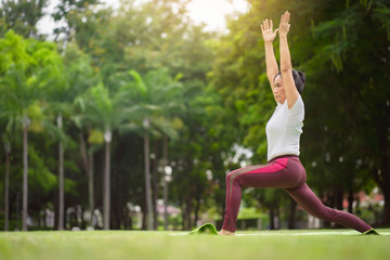 Fototapeta premium Senior Asian woman practicing yoga exercise outdoor in the morning. senior healthy lifestyle concept.