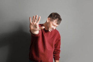 Portrait of stressed man on grey background