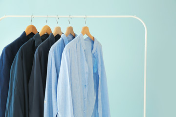 Obraz premium Rack with stylish clothes on color background