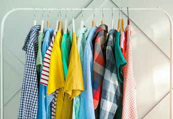 Rack with stylish clothes on grey background
