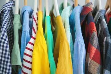 Hangers with stylish clothes, closeup