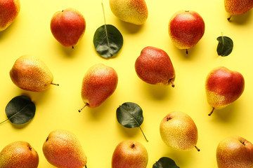 Sweet ripe pears on color background