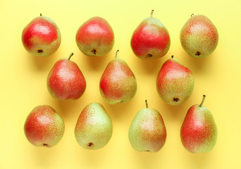 Sweet ripe pears on color background