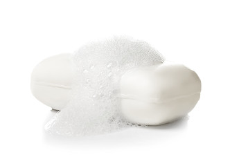 Soap bar with foam on white background