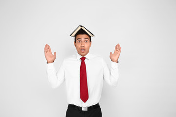 Shocked African-American businessman on white background