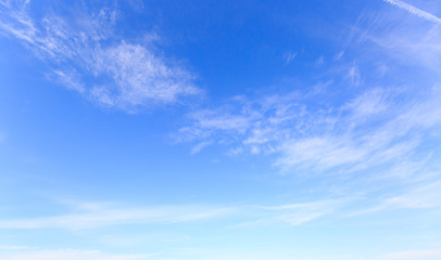 Naklejka na ściany i meble blue sky with fluffy wispy clouds