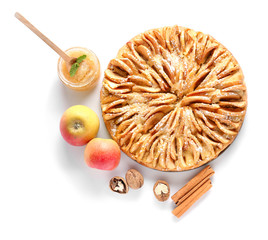 Sweet apple pie and ingredients on white background