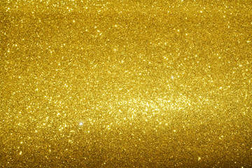 gold Sparkling Lights Festive background with texture. Abstract Christmas twinkled bright bokeh defocused and Falling stars. Winter Card or invitation