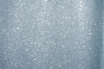 Silver Sparkling Lights Festive background with texture. Abstract Christmas twinkled bright bokeh defocused and Falling stars. Winter Card or invitation