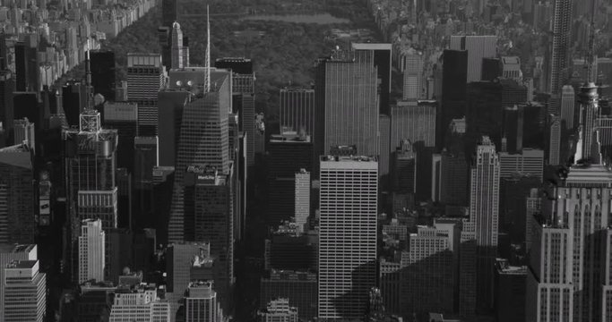 Black and white aerial zoom from midtown into Central park, drone