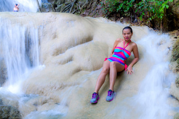 Woman and bikini pretty in waterfall