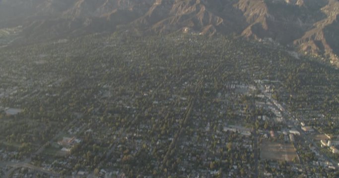 Aerial shot, day, stunning distant view of beautiful mountains with pasadena at its foothills, drone
