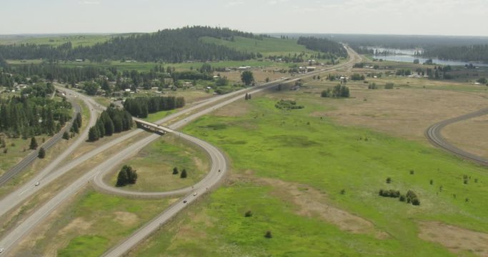 Helicopter aerial shot of highway among forest plains, drone 