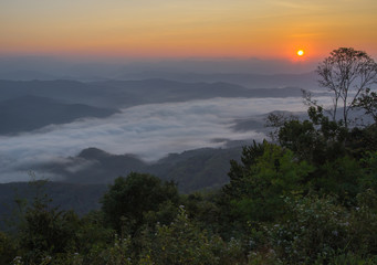 sunset sky over mountain and sunrise on white fog in the morning
