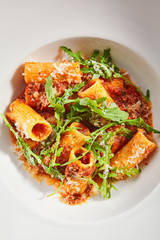 Tasty rigatoni with bolognese sauce top view