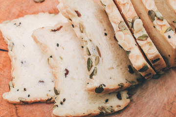 Homemade High fiber natural health food Sliced rye bread on cutting board. Whole grain rye bread with seeds