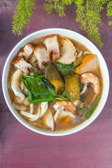 Vertical photo of Vietnamese seafood and roasted pork noodle soup