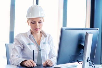 Female designer in office working on architects project