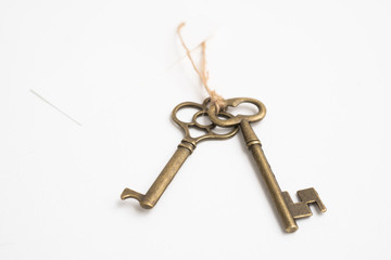 Old vintage brass key on white background