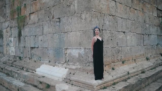 Beautiful young attractive Muslim woman in long black dress standing on the corner of Hidirlik tower, historical place