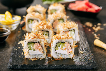Macro Shot of Eating Katsuobushi Uramaki Sushi Rolls with Fried Salmon