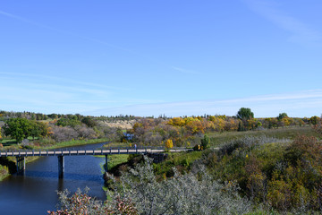Fototapeta na wymiar bridge over autumn colored banks