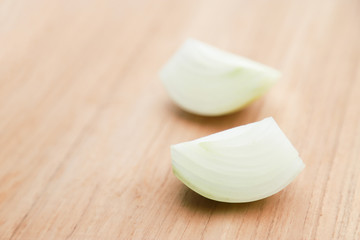 onion big slice on wooden table 